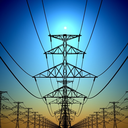 Electricity pylons and lines with sun at background.の写真素材