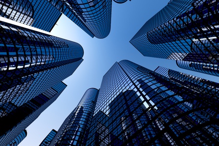 Low angle shot of modern glass city buildings with clear sky background.