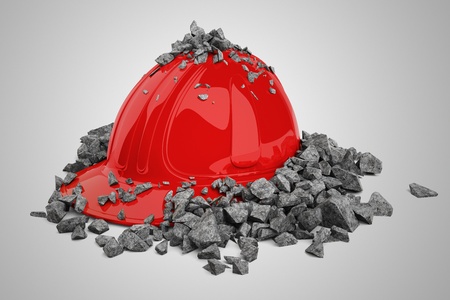 Red safety helmet and brick broken into pieces.