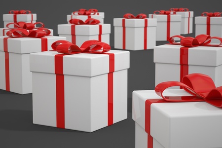Multiple white gift boxes with red ribbons arranged on a gray background. Suitable for any special occasion.の写真素材