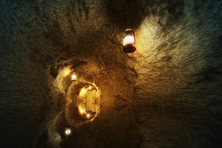 View from indside the stone cave. Hanging lamps light up the way. Cave reflects on water. Represents peace, beauty of nature, adventure or mystery.の写真素材