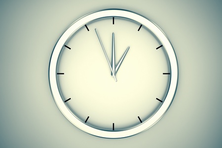 A simple modern clock hanging on a wall on a bright background  May represent passage or shortage of time, house or office decorations の写真素材