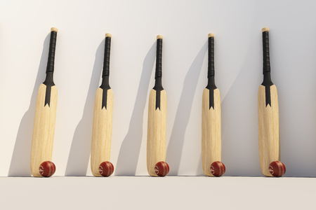Cricket bat with ball at the white wallの写真素材