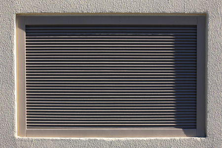 Metal blinds inserted into the plastered wallの写真素材