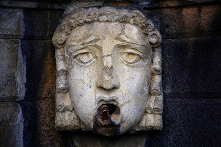 Old bas-relief in the form of the female headの写真素材