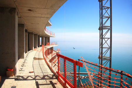 Construction of the building from reinforced concrete against the background of the sea