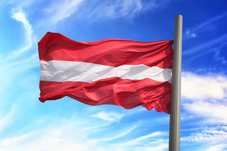 Flag of Latvia against the background of the skyの写真素材