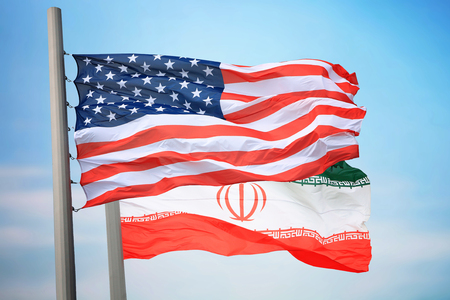 Flags of the USA and Iran against the background of the blue skyの写真素材