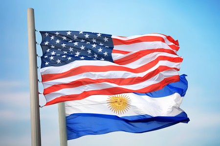 Flags of the USA and Argentina against the background of the blue skyの写真素材