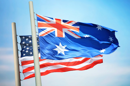 Flags of the USA and Australia against the background of the blue skyの写真素材