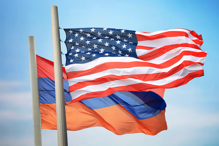 Flags of the USA and Armenia against the background of the blue skyの写真素材