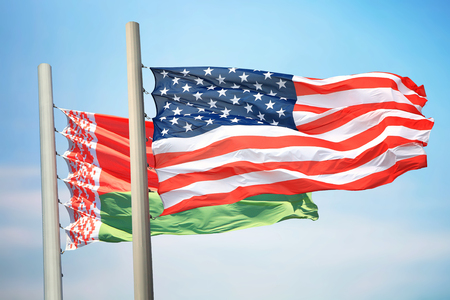 Flags of the USA and Belarus against the background of the blue skyの写真素材