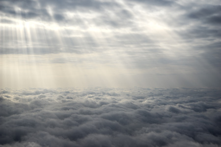 Yellow Sun Rays Over The Grey Cloudsの写真素材