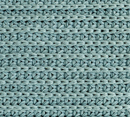 Green Knitted Pattern. Crocheted Fabric Texture backgroundの写真素材
