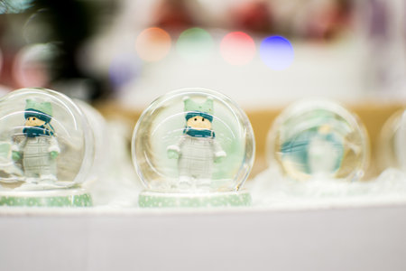 Souvenir snow globe with cute figures in shopping centerの写真素材