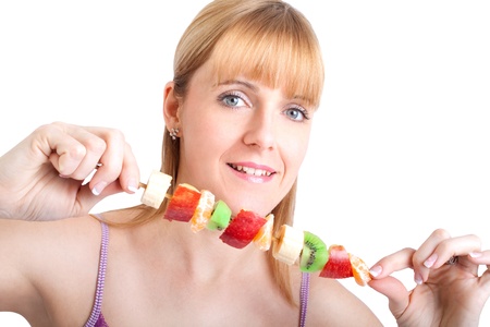 Young smiling woman with fruits and vegetables. Over white background の写真素材
