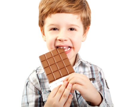 Close Up of Young Boy Eating A chocolate bar の写真素材