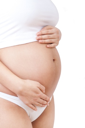 Image of pregnant woman touching her belly with hands, isolated の写真素材