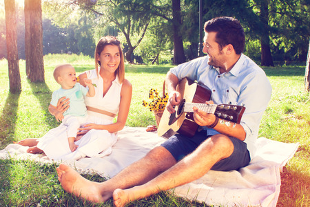 Happy young family spending time outdoor on a summer dayの写真素材