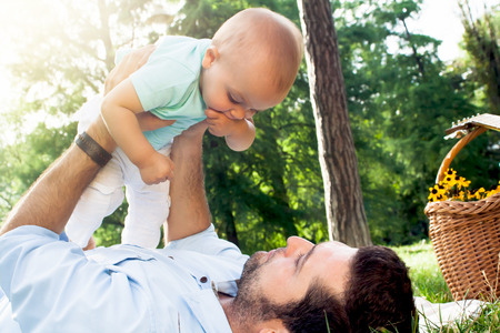Happy young family spending time outdoor on a summer day, father and sonの写真素材