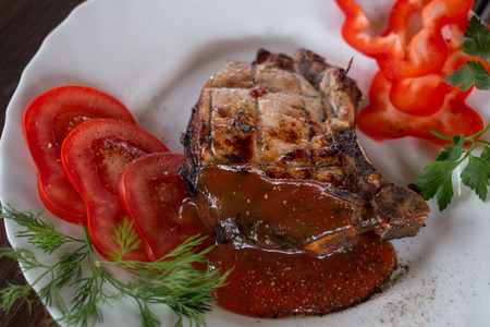 Big juicy grilled steak with greens on the plateの写真素材