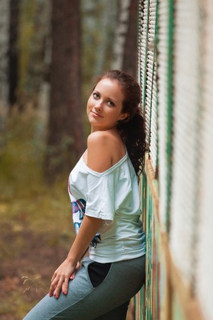 Cropped view of beautiful young woman walking in forest barefootの写真素材