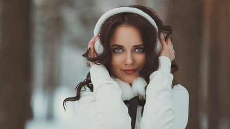 Beautiful young girl in a white winter forestの写真素材
