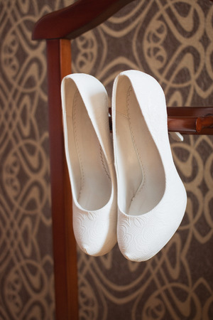 Cute stylish beige high heels with a bow on the background room, glamor, fashion, wedding.の写真素材