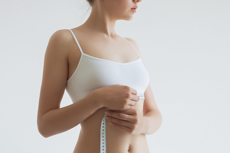 Young beautiful girl measures your body parts of roulette.の写真素材