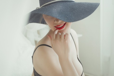 Young girl in hat with bare Breasts.の写真素材