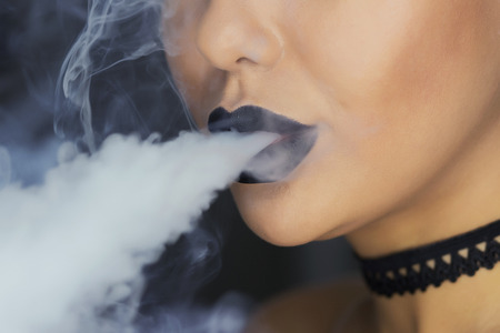 Portrait of girl in a hookah. with the smoke one more view