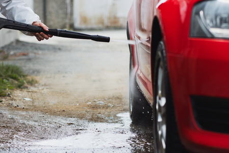 Summer Car Washing. Cleaning Car Using High Pressure Water.の写真素材