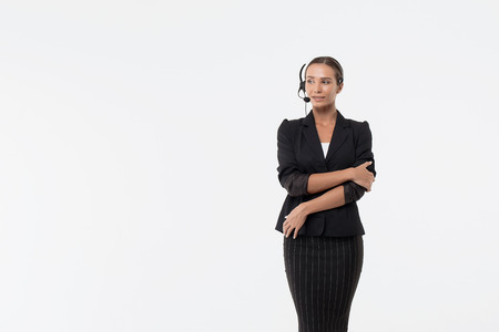 Isolated attractive woman in black costume with headphone looking awayの写真素材