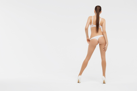 Perfect body young woman on a white background in sexy lingerieの写真素材