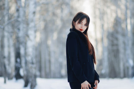 Laughing beautiful girl portrait in winter time with snow.の写真素材