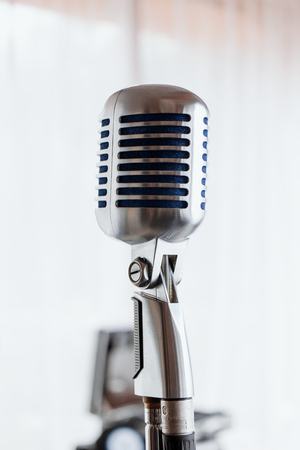 Microphone. Retro microphone. A microphone on stage. A pub. Bar. Restaurant. Classic. Evening. Night show. European restaurant European bar American restaurant American barの写真素材