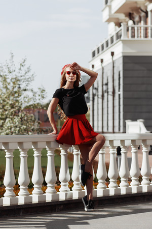 Portrait of beautiful young blonde woman wearing stylish black outfit, she smiling on urban background, happy time, Travel Concept.trendy girl in stylish sunglasses ad leather jacket in the street.の写真素材