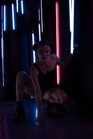 Sensual woman under neon illumination
