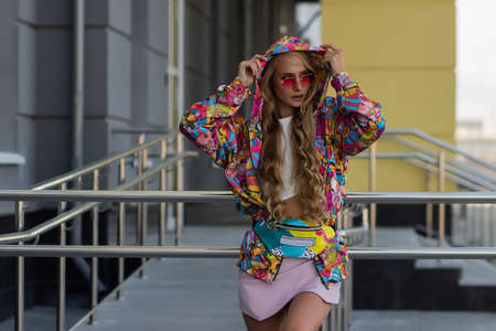 Trendy female leaning on railingの写真素材