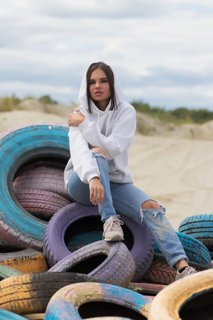 Seductive woman in denim outfit in natureの写真素材