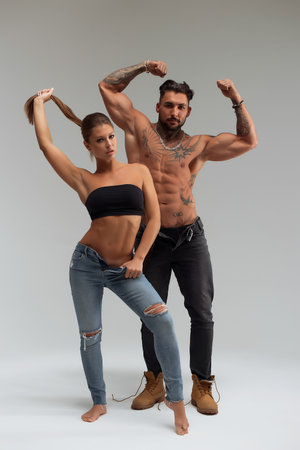 Woman hugging muscular man from behindの写真素材