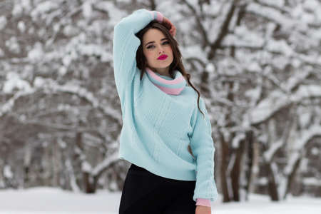 Beautiful girl in winter forest