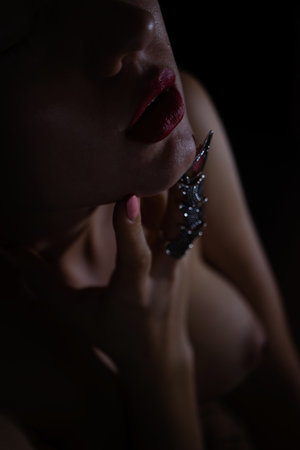Beautiful woman with a stylish silver claw ring on her finger
