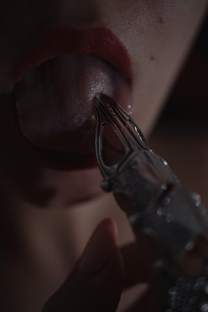 Beautiful woman with a stylish silver claw ring on her fingerの写真素材