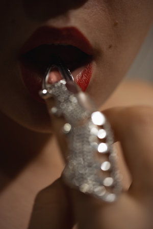 Beautiful woman with a stylish silver claw ring on her fingerの写真素材