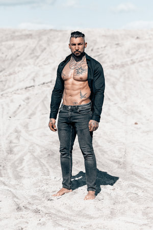 Sexy portrait of handsome muscular topless male model at the beach.の写真素材