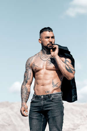 Sexy portrait of handsome muscular topless male model at the beach.の写真素材