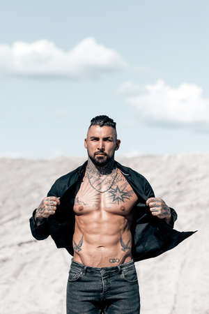 Sexy portrait of handsome muscular topless male model at the beach.の写真素材