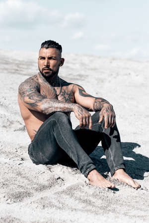 Sexy portrait of handsome muscular topless male model at the beach.の写真素材