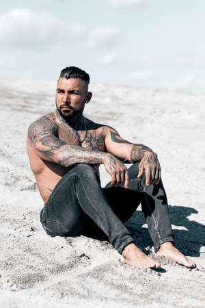 Sexy portrait of handsome muscular topless male model at the beach.の写真素材